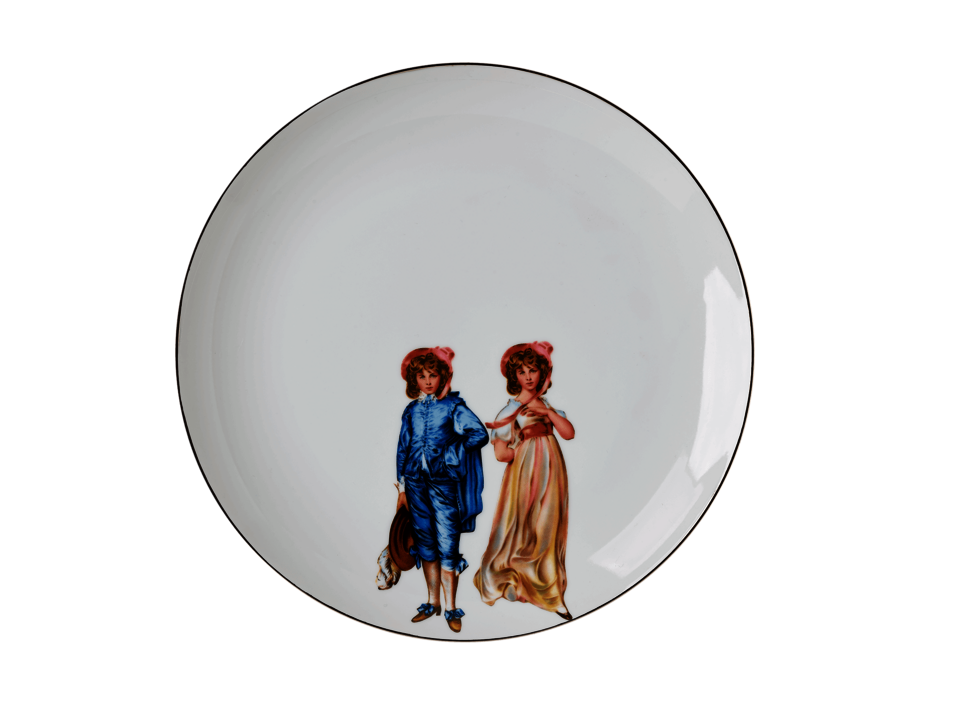 A white ceramic plate with an illustration of Victorian-style twins 