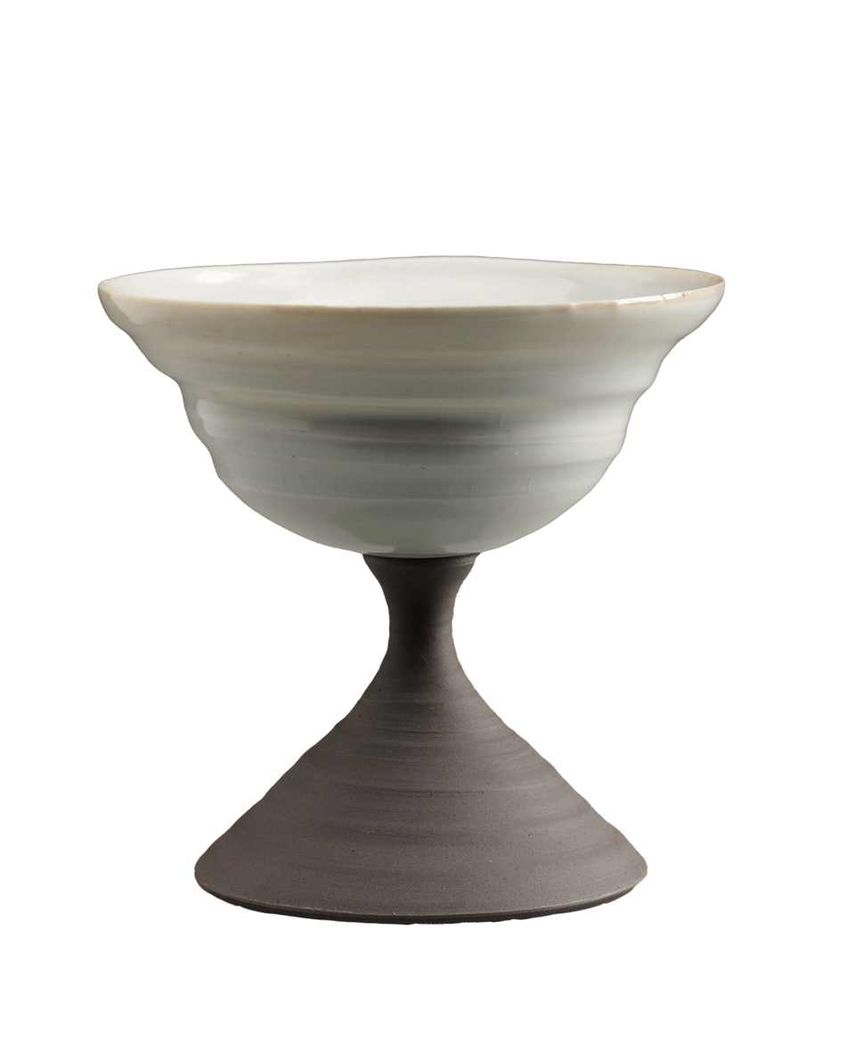A compote in an hourglass shape. A white bowl rests on top of a gray base.