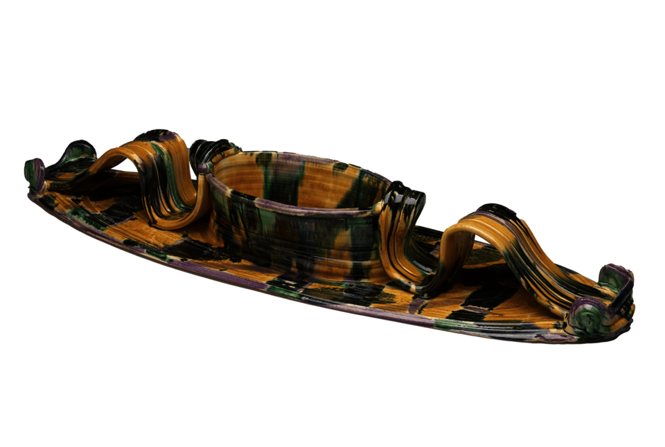 A long oval platter with attached oval bowl in the center. Long curving handles on either side of the bowl. Covered in mottled shades of yellow, green, and black
