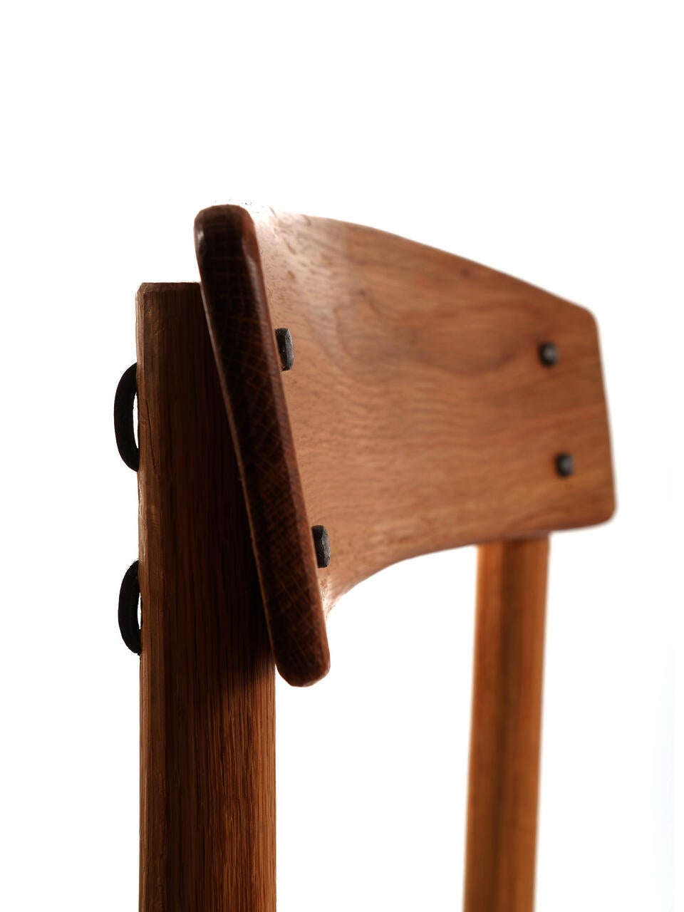 Detail photo of Kentucky Danish showing the attachment of the back rest. The original J39 backrest is attached via screws covered by wood plugs. Screws were out of reach of the craftspeople of the Appalachian Mountains in the 18th and 19th century, so instead the backrest of Kentucky Danish is attached with cut and clinched nails.