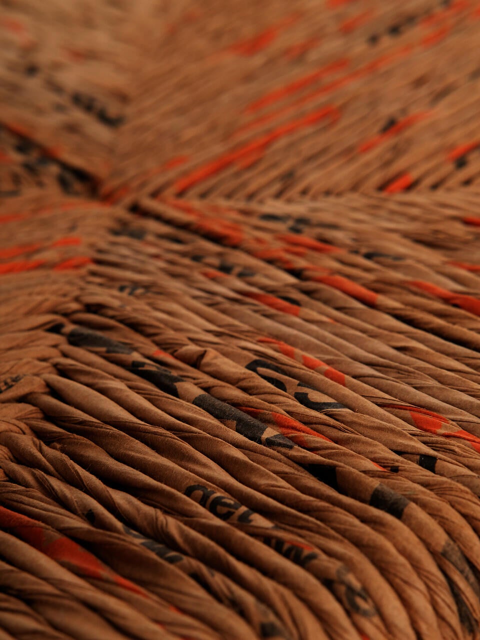 Photo of the woven seat of Big Box Vernacular, made from cut and twisted paper bags intended for lawn waste.