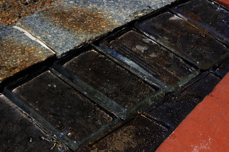 Details of the glass block with the poem engraved on the back