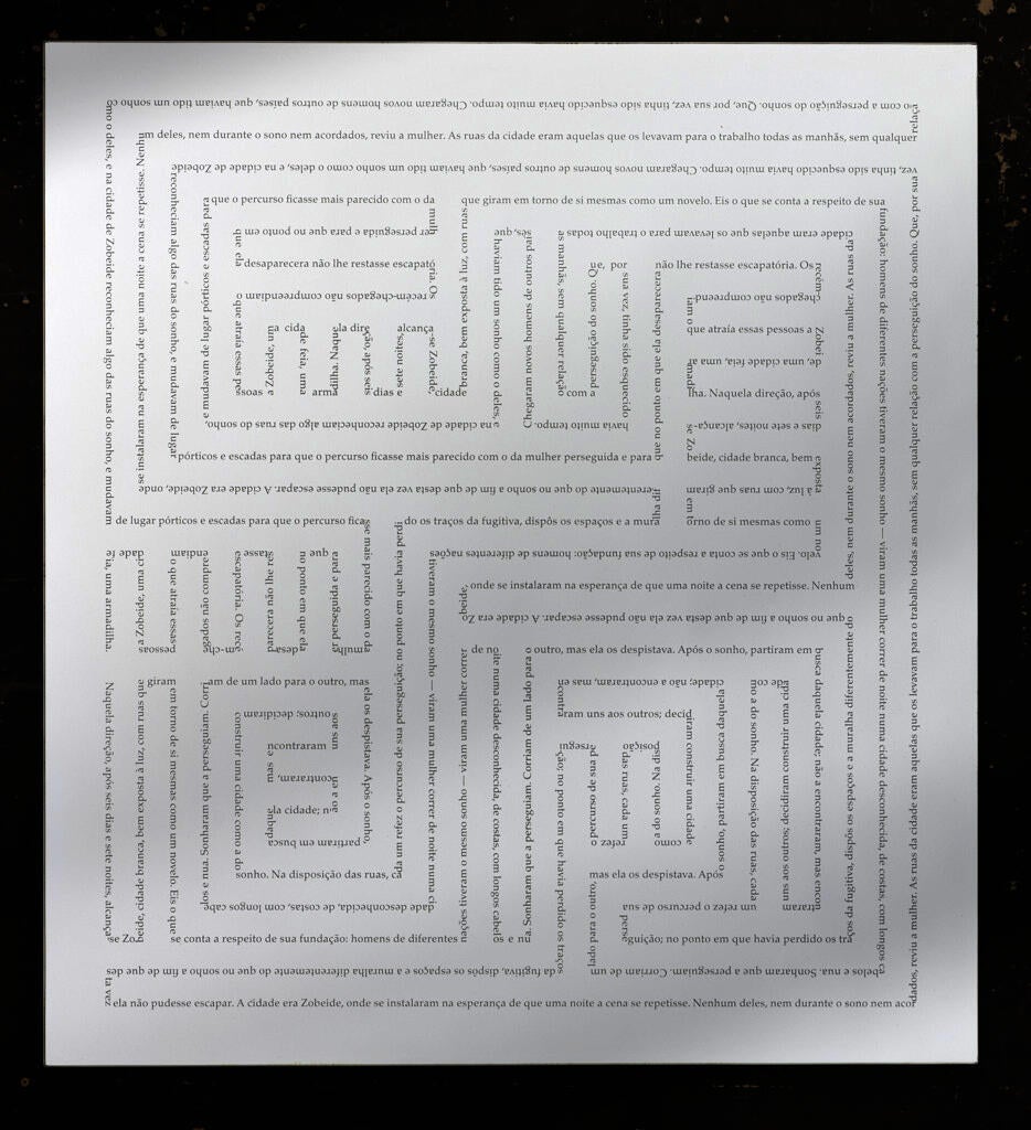 Perfectly even maze-like geometric design on white. The design looks gray, but closer examination shows that it’s actually text.