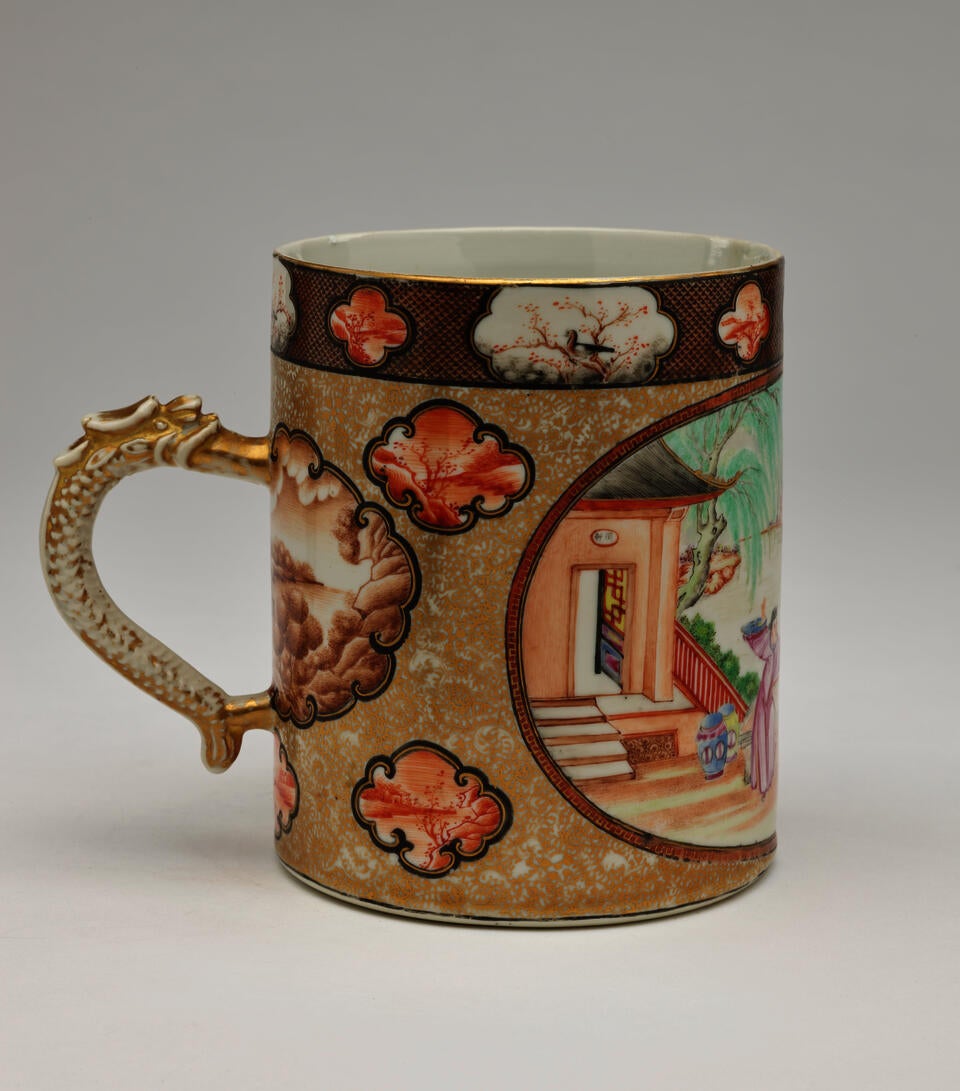 A porcelain tankard with a handle that has delicate enamel and gilded decorations.