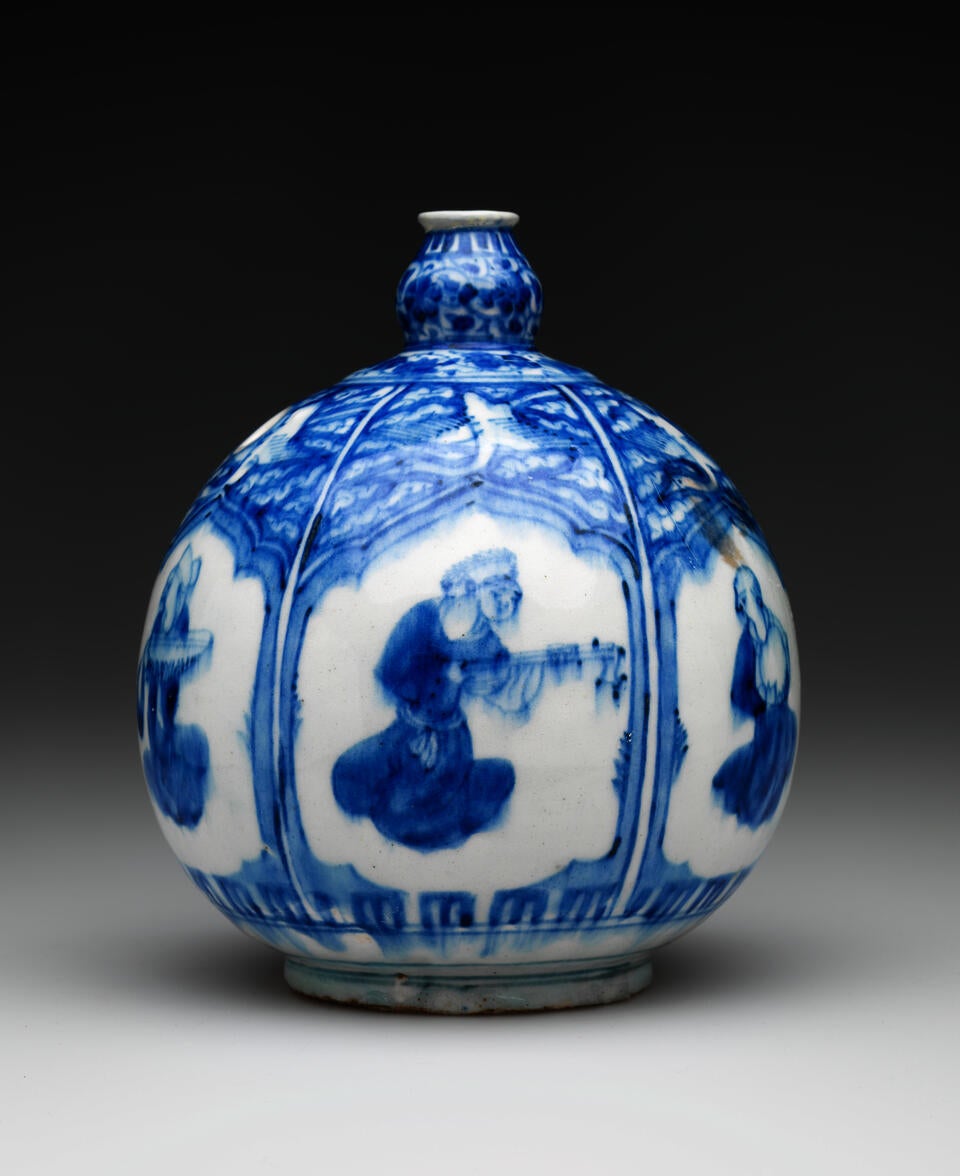 A bulbous white and blue vessel with a small neck and a hole on the side. There is a repeating window shape with different figures inside the vignet. 