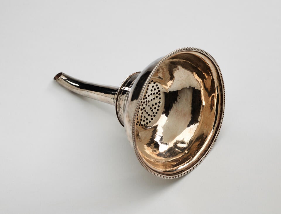  A simple silver wine funnel that goes from large to a very skinny section.