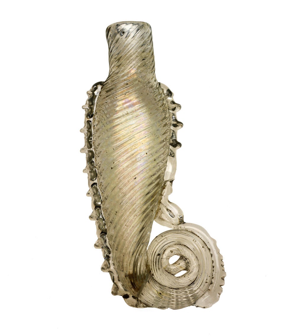 A glass teardrop vial with spiral scoring. The bottom of the vial curls into a spiraling tail.