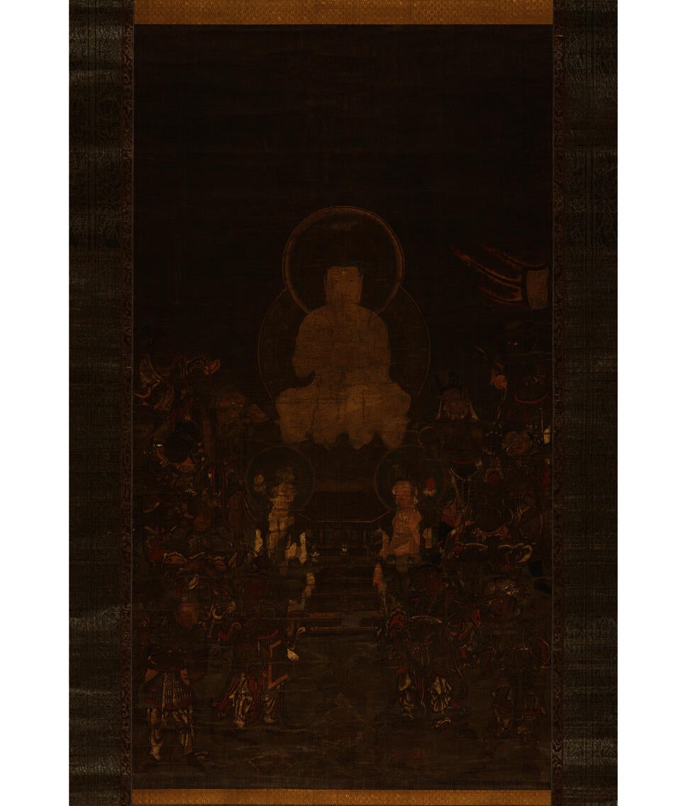 Earthy and faded ink painting on cloth depicting a haloed, centrally seated Buddha. At his feet are two smaller haloed men who are surrounded by a crowd of people.