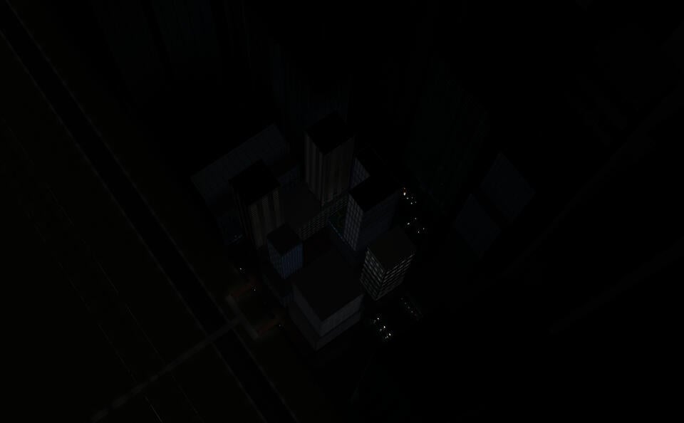 This is an aerial view of a block of stilted buildings at night.