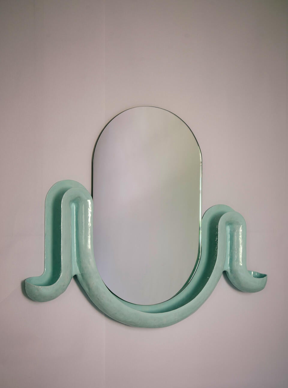 Two blue swell with a racetrack shaped mirror in the middle.