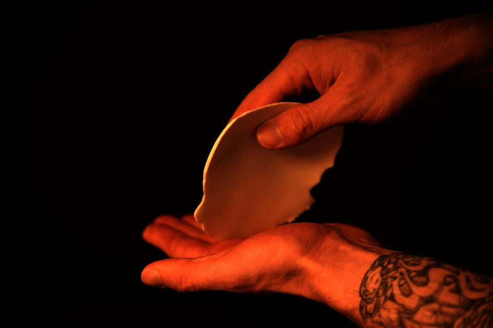 A hand holding a weird object.