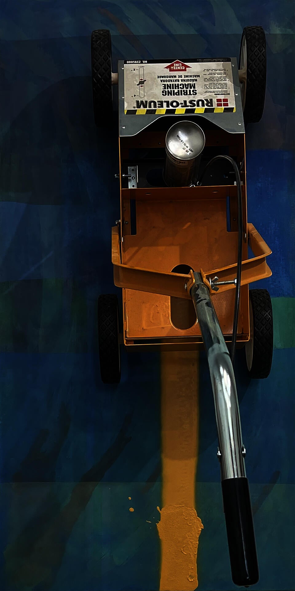 Abstract painting with parking lot line drawing tool attached vertically.  It has finished drawing half across the painting