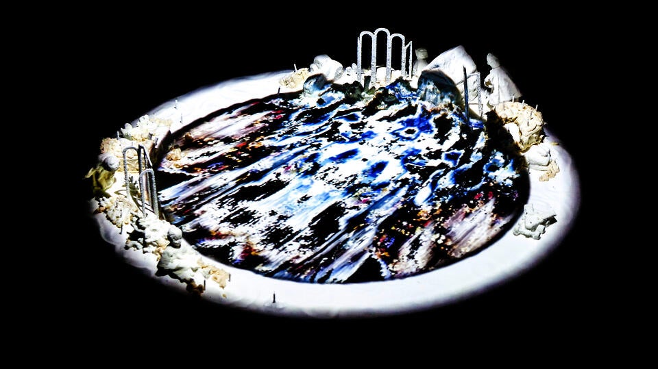 Photogrammetry animation projection installation on pool of salt figurines and birthday cake