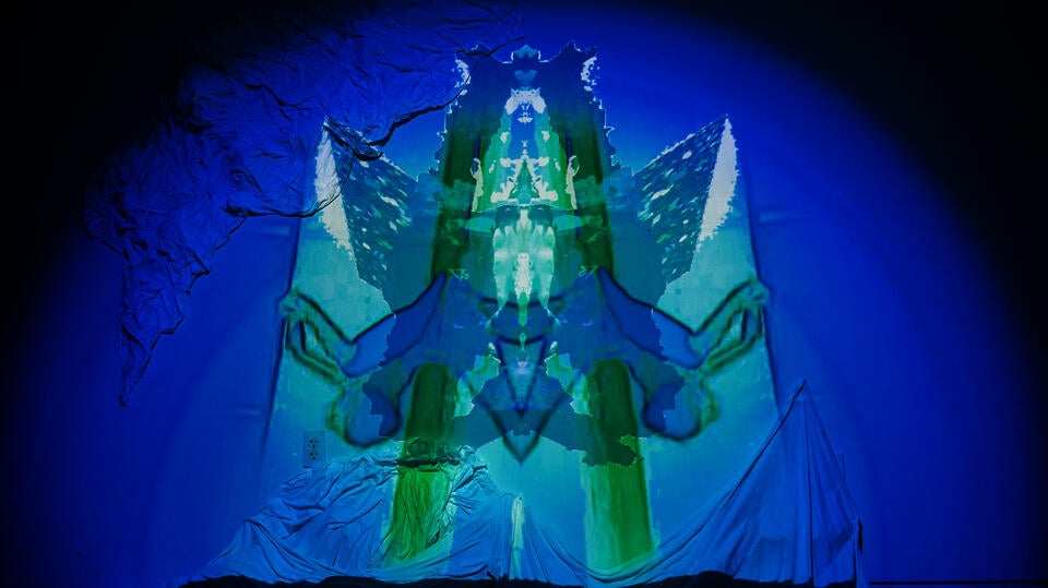 Photogrammetry animation of Cherenkov radiation from RINSC nuclear reactor projected on an installation of bedsheets, salt, and melatonin.