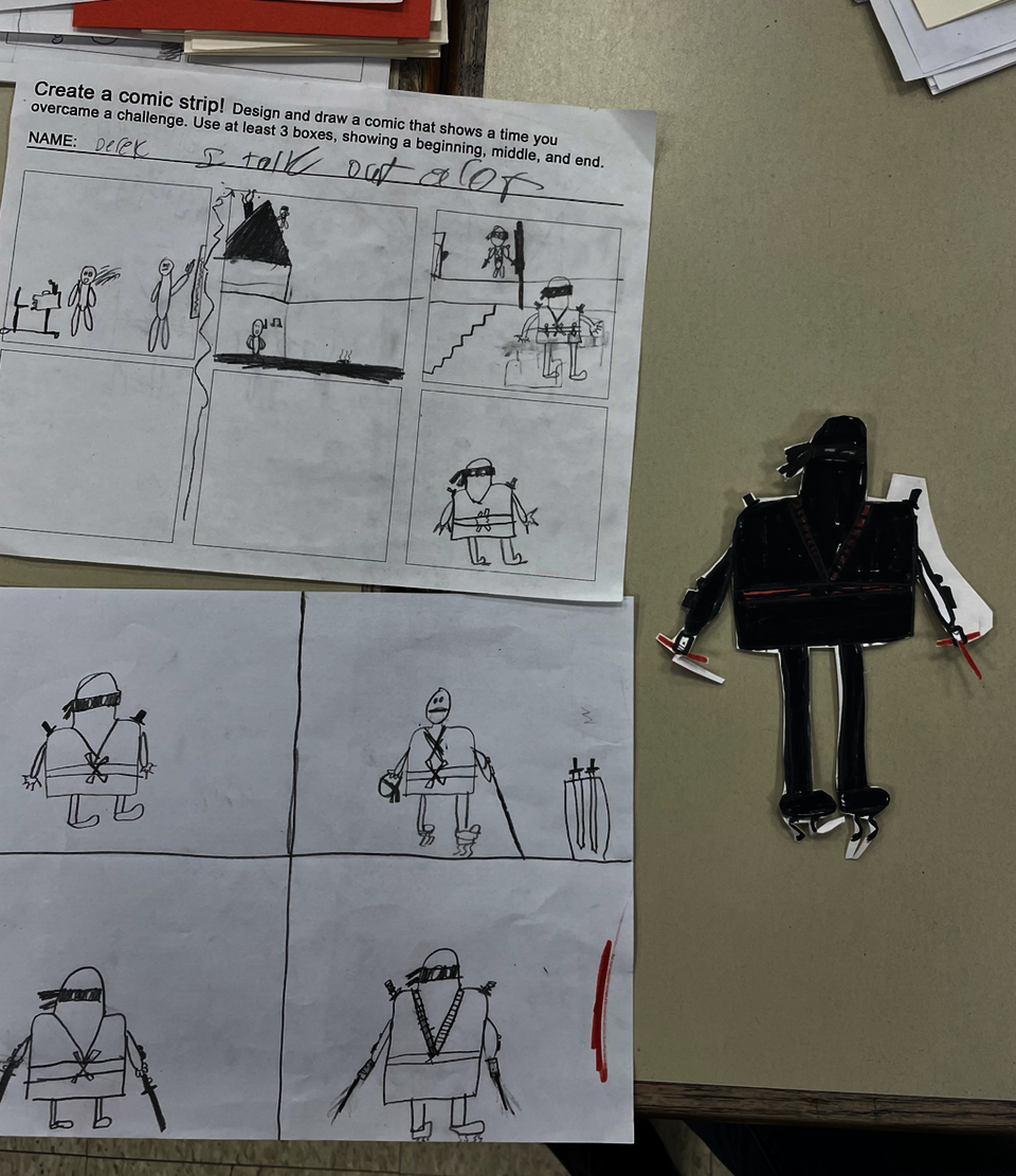 Student work on table, shows process of planning, sketching, and creating. 