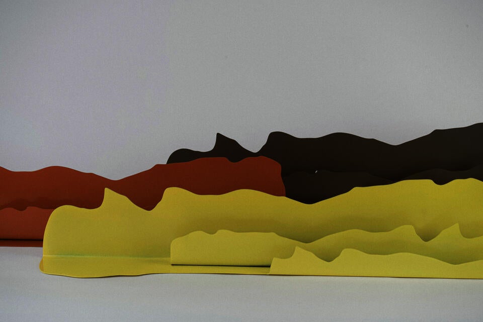 A collection of three steel wall mounted shelves. 