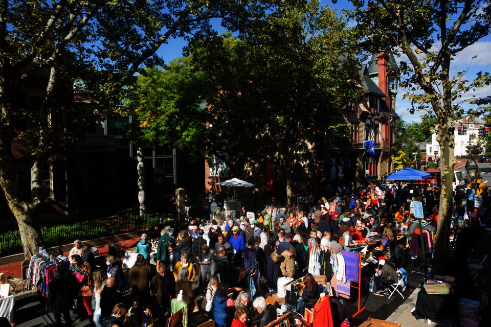 A crowd of people fill a street for a sidewalk craft sale in front of the Benefit Street entrance of the RISD Museum.