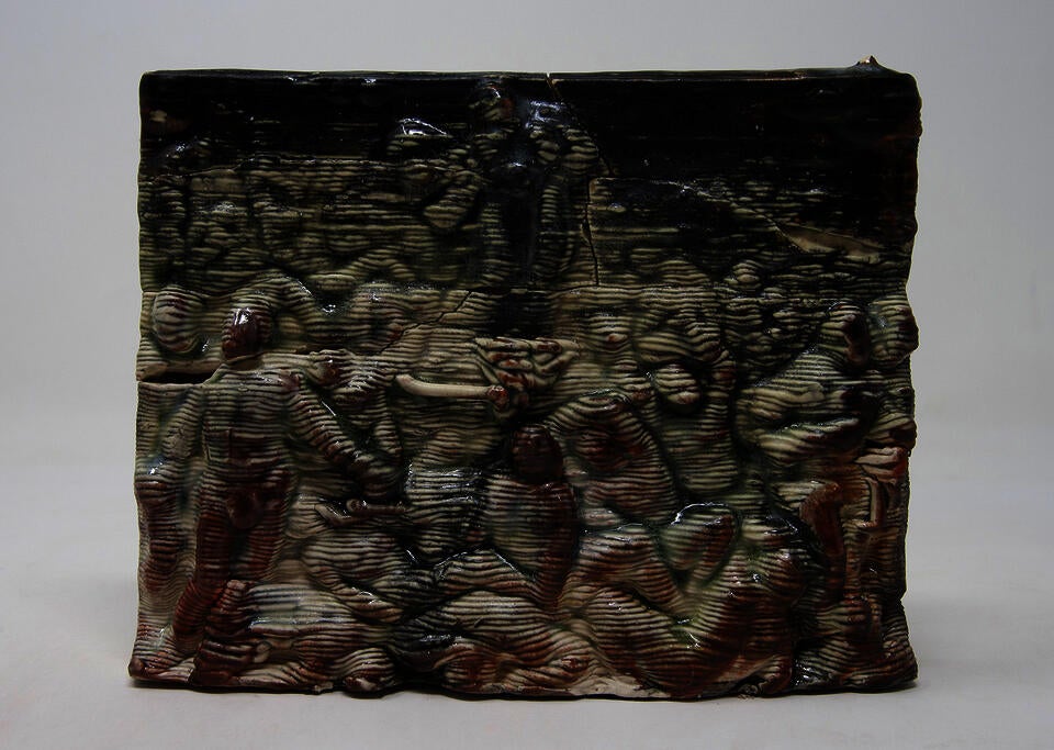 Black and red glazed ceramic tile scene showing crowd of people looking towards figure in the sky