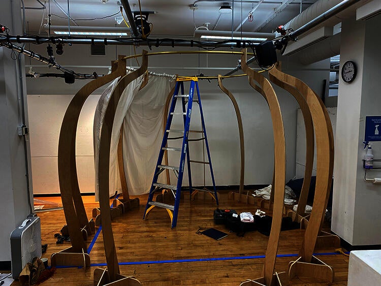 A spherical space created by curved wooden pieces standing eight feet tall connected with a metal ring at the top