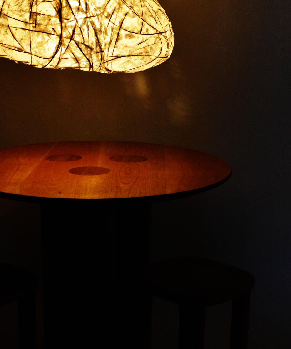 A circular dining table meant for gathering with loved ones.