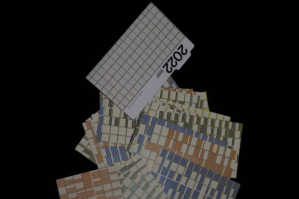 A folder representing a stock portfolio with prints of patterns generated in Google Sheets spilling out.