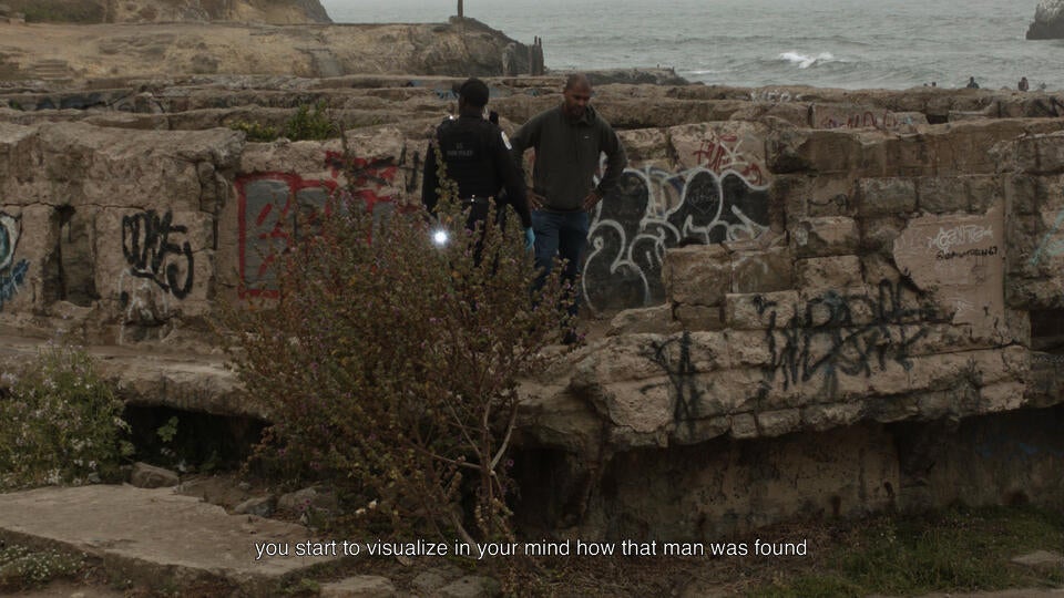 Two men are standing in the ruins