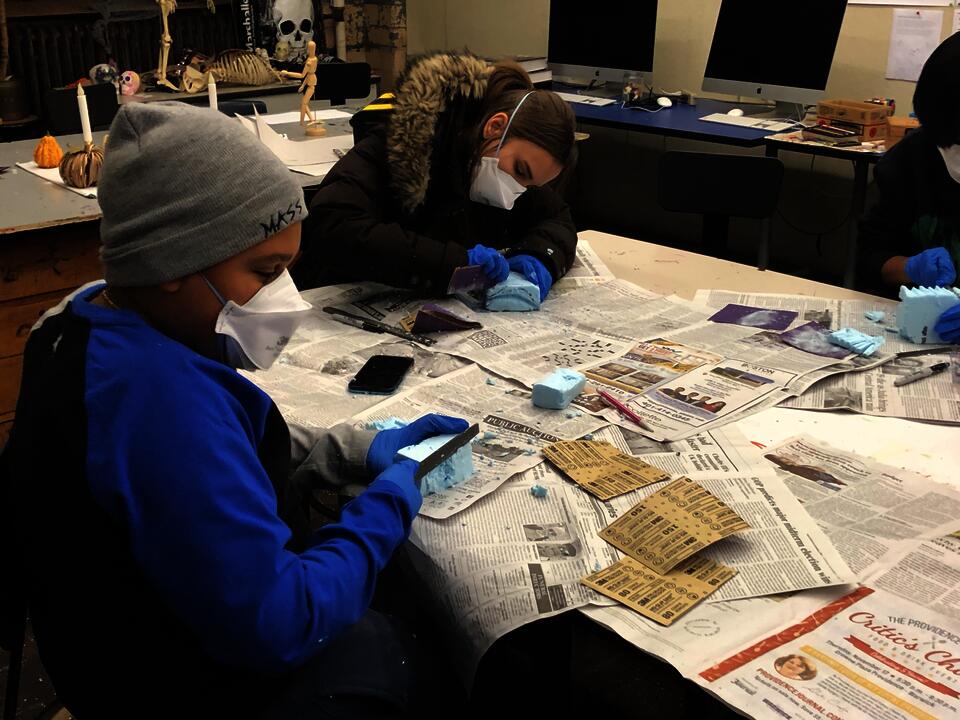 Students Benny and Sophia working with blue foam.