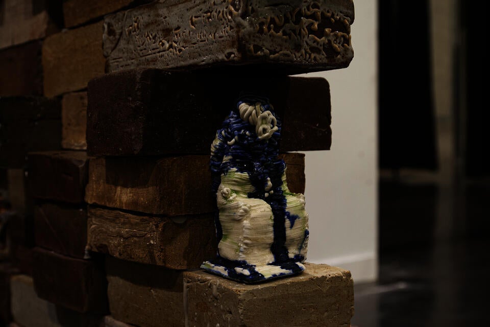 close up of brick wall filled with small objects printed from historical scans