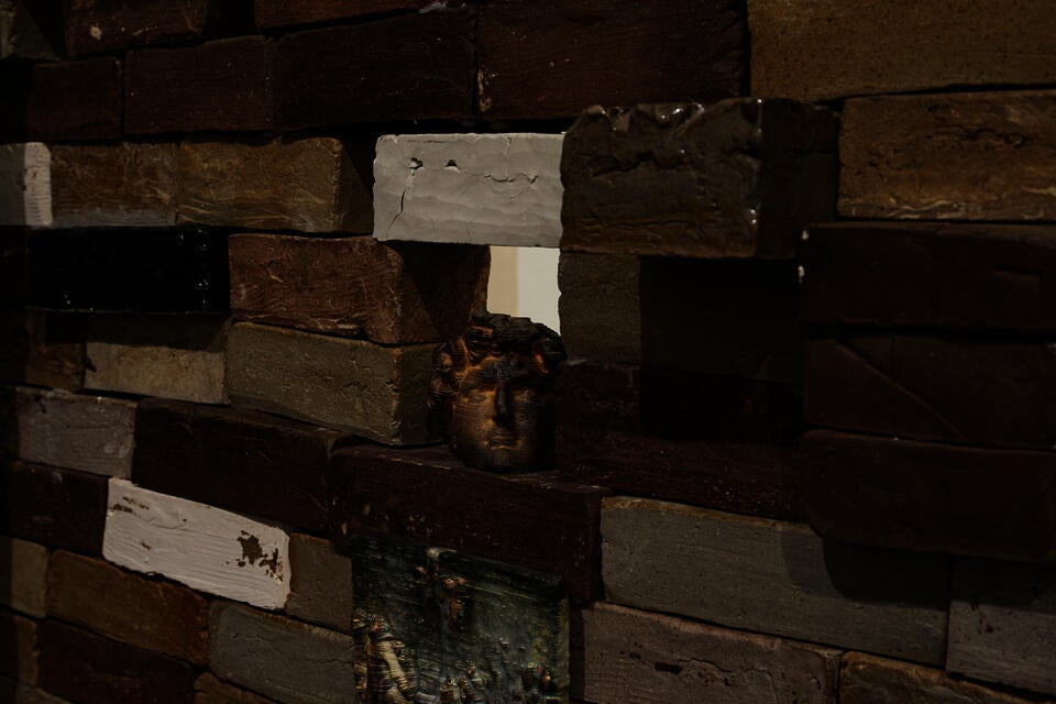 close up of brick wall filled with small objects printed from historical scans