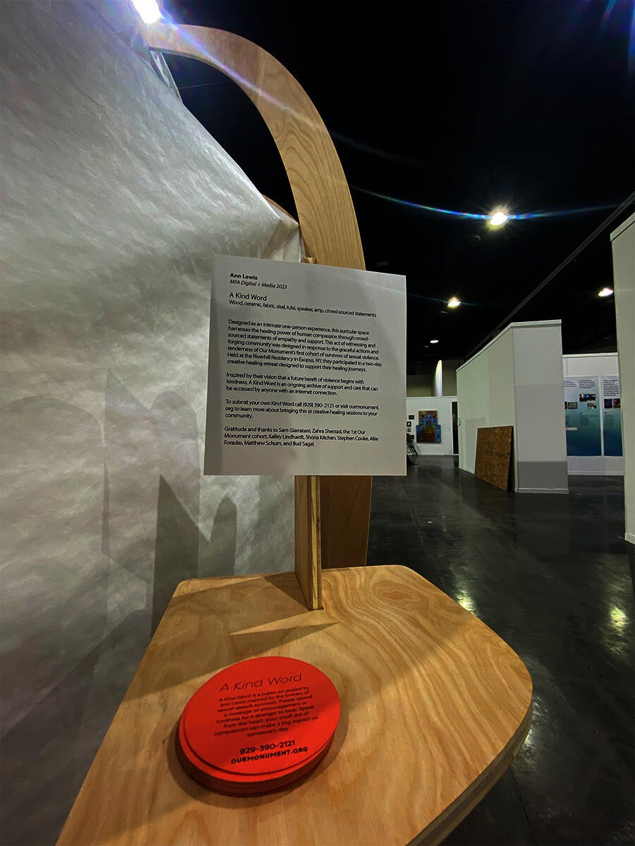 A wooden stand holds orange and white cards explaining the monument