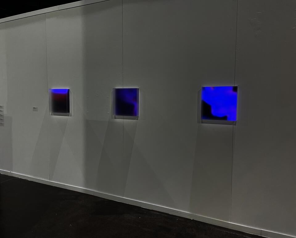 Photo documentation of installation featuring a close-up of the three light boxes.