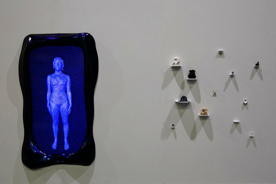 A blue and purple frame surrounds a screen showing a cyborg like figure