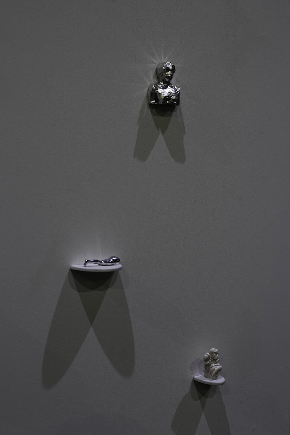 A detail shot of multiple sculptures on individual shelves