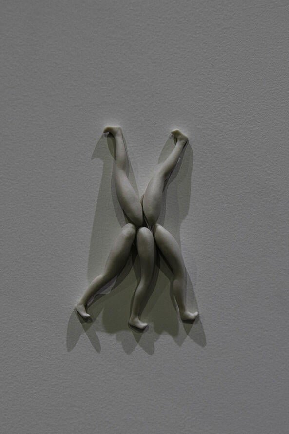 A detail shot of multiple sculptures on individual shelves