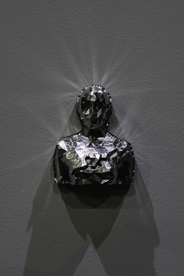 A detail shot of multiple sculptures on individual shelves