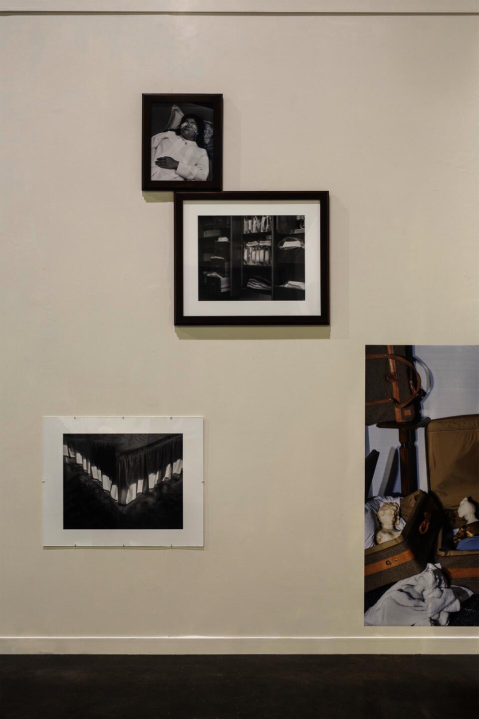 .Arrangement of four photographs on gallery wall.