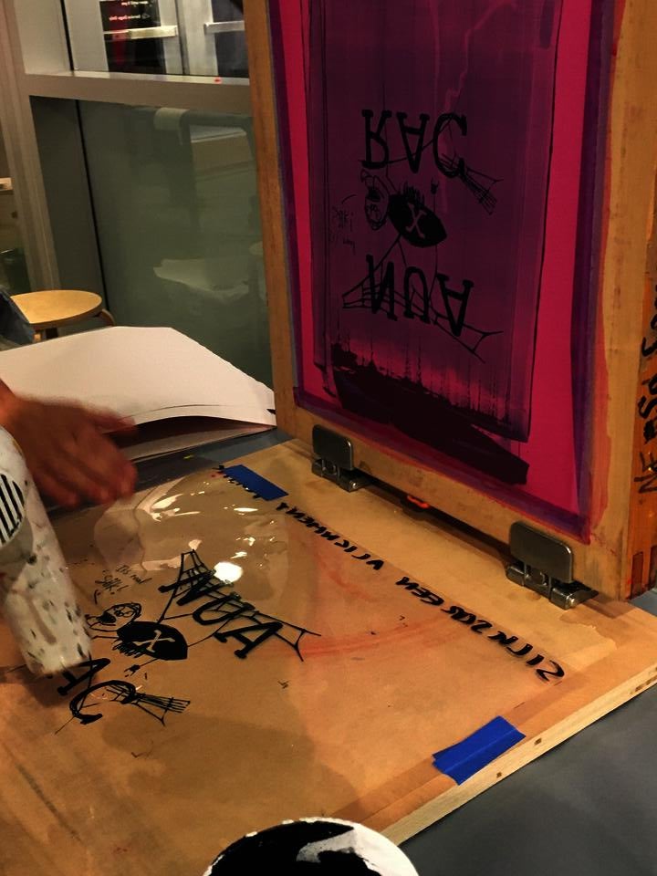 Screen printing screen with a design that featured NUA (New Urban Arts) and RAC (RISD Art Circle) with a small spider