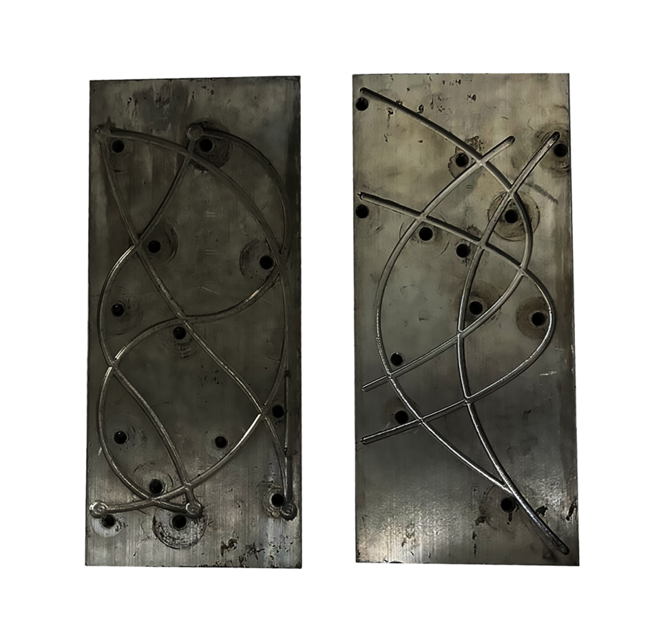These jigs were used to secure the wire before it went into a furnace at above 500°C to embed a new shape memory into each individual transition temperature wire.
