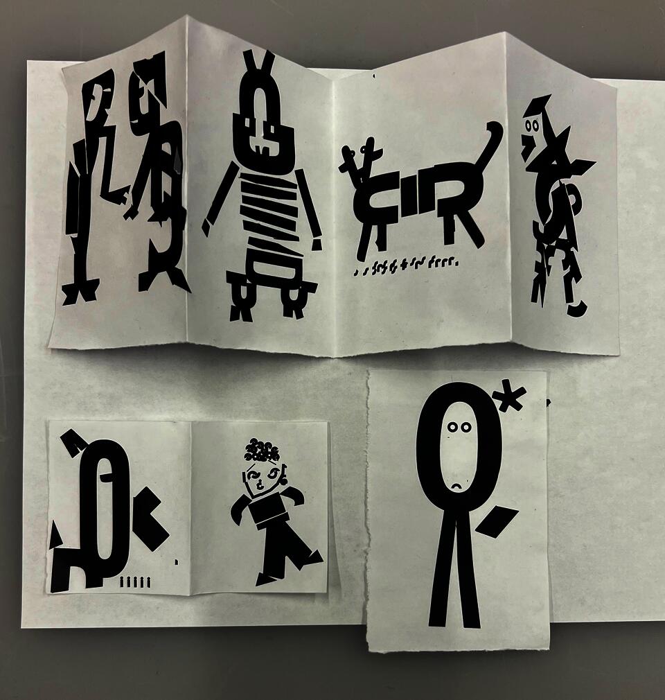 Black Vinyl characters on white background against grey backdrop
