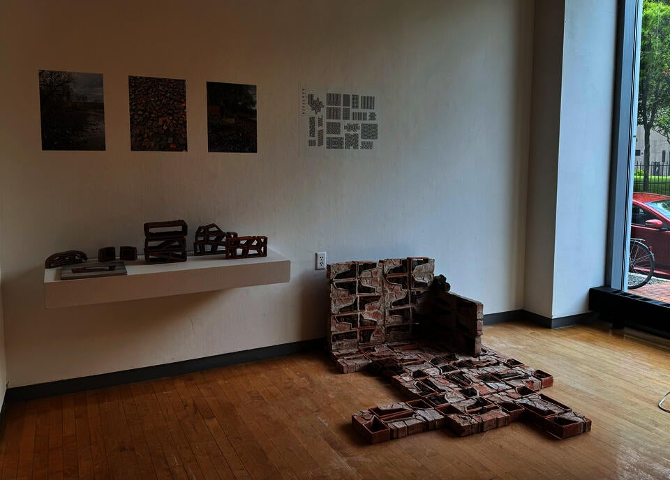 Image shows installation of brick wall, a floating shelf with several conceptual models. Drawings on the wall include the beach at Kingston Point, my perspective rendering, and the alternative modular possibilities of the system.