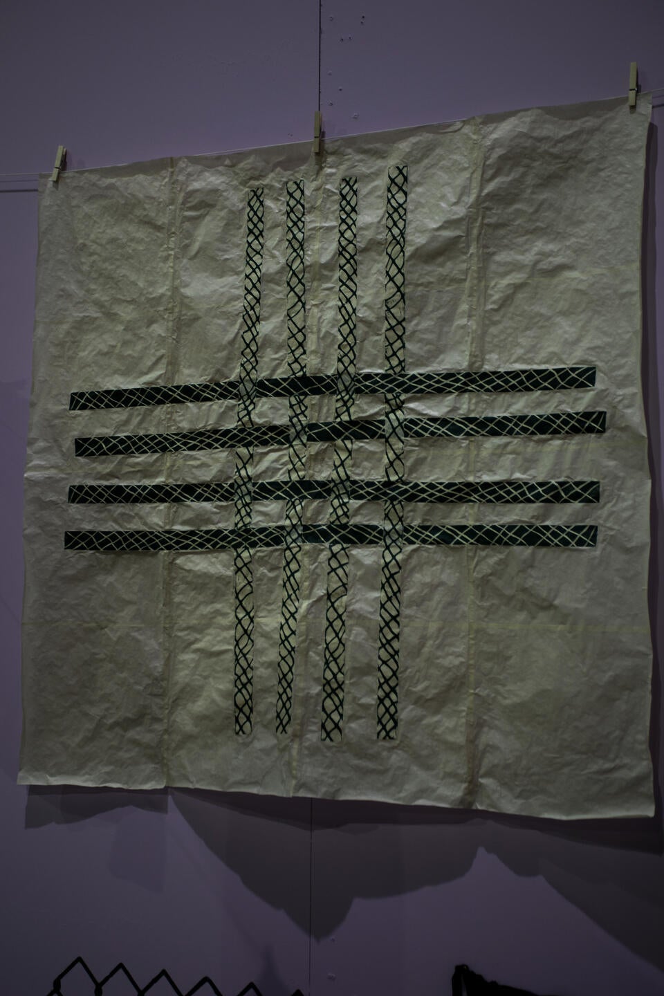 image of green collaged prints assembled in a woven pattern