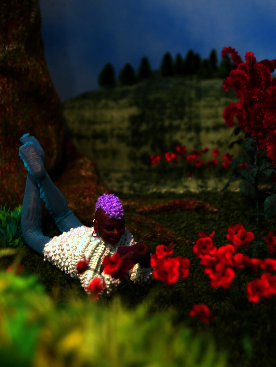 A smiling figure reads "Beyond the Gender Binary" in a grassy garden under a partially cloudy blue sky
