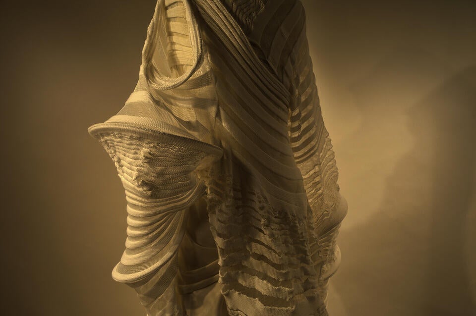 The dimensional garment, inspired by a moth and the empty cocoon is fully wearable and draped around the body form.