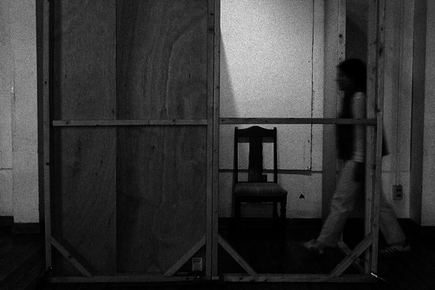 Image of constructor walking into booth to a chair