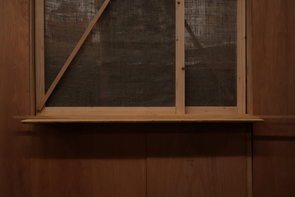 Close-Up View of the dividing screen between the two sides of the booth - made from Burlap and Wood