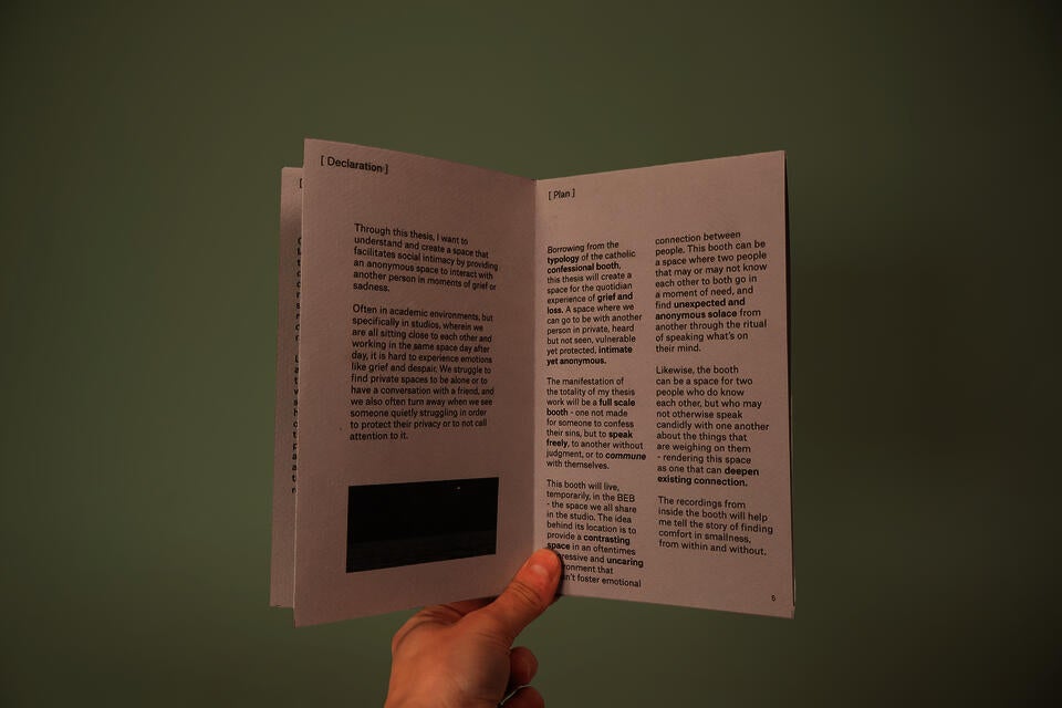 Small gray zine explaining the purpose of the thesis booth and the plan of action for development