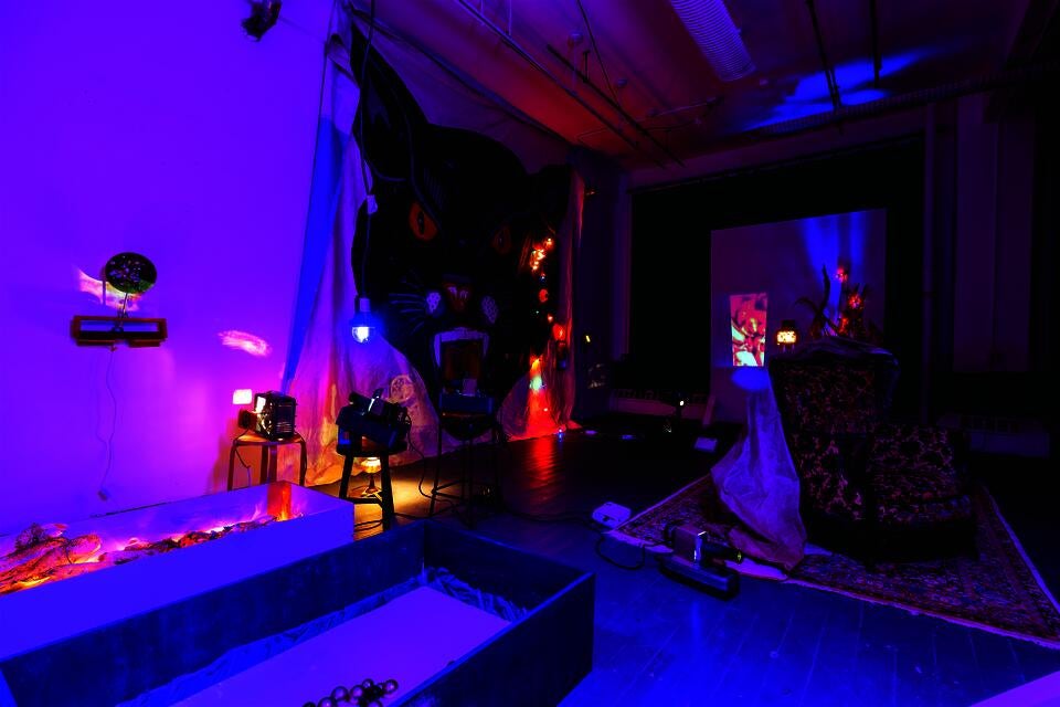 An installation piece that contains found objects, christamas tree lights, and projections. 