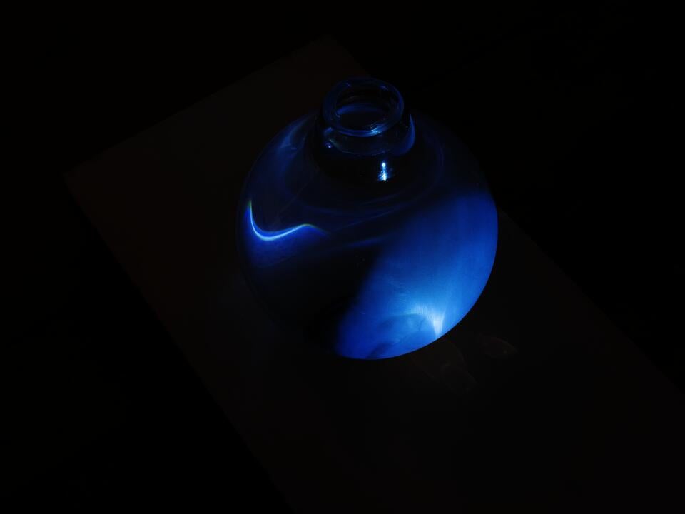 Image of a glass orb with blue light, water