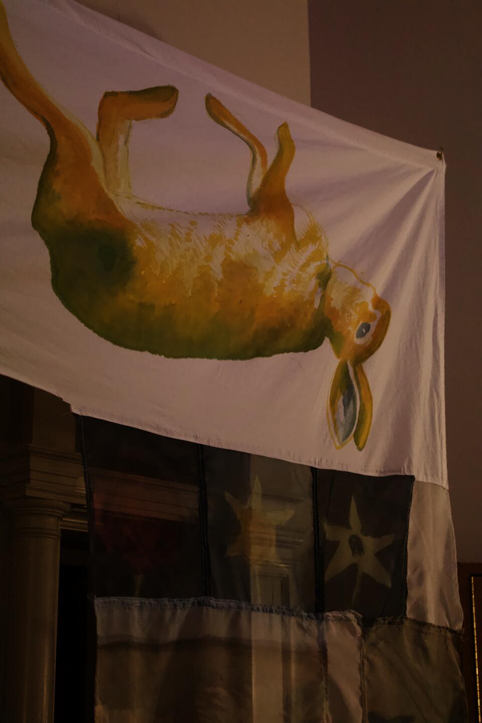 Yellow and green painting of dead rabbit 