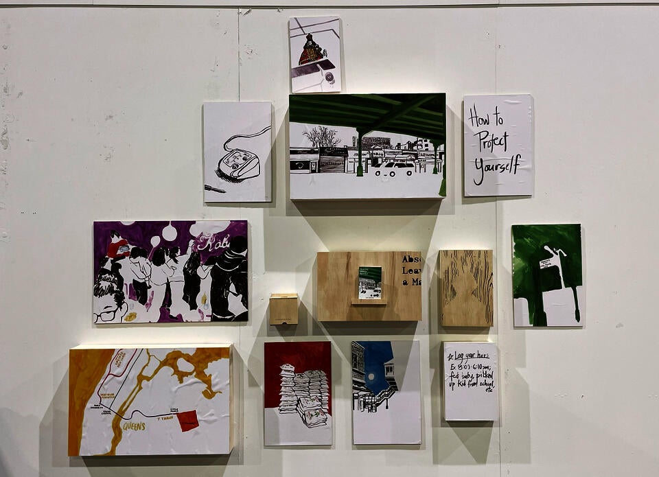 Eleven minimalist acrylic ink illustrations of Little Manila of varying sizes mounted on plywood. In the center, a plywood box housing the zine "Tracing Little Manila." Beside it a small box containing postcards.